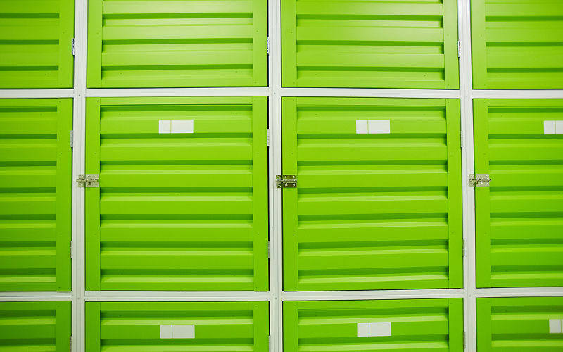 Rows of green metal storage lockers for retail inventory.